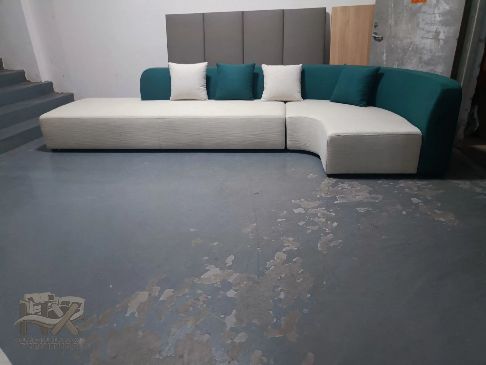 A white sectional uses deep square cushions and a low corner return above a concealed base.