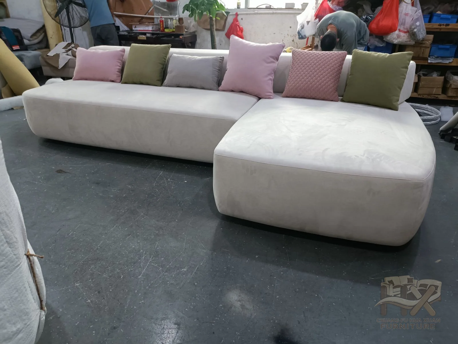 An ivory sectional bends its long cushion run around a softly rounded corner.