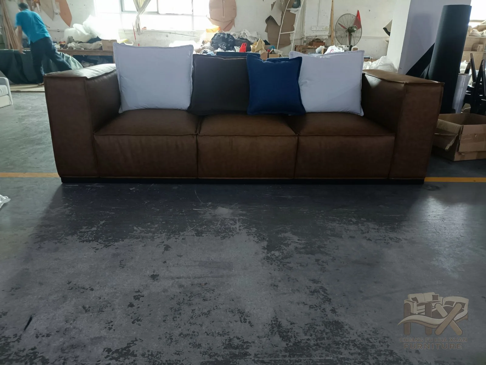 Brown upholstered modules create a low sofa with broad block seats and straight backs.