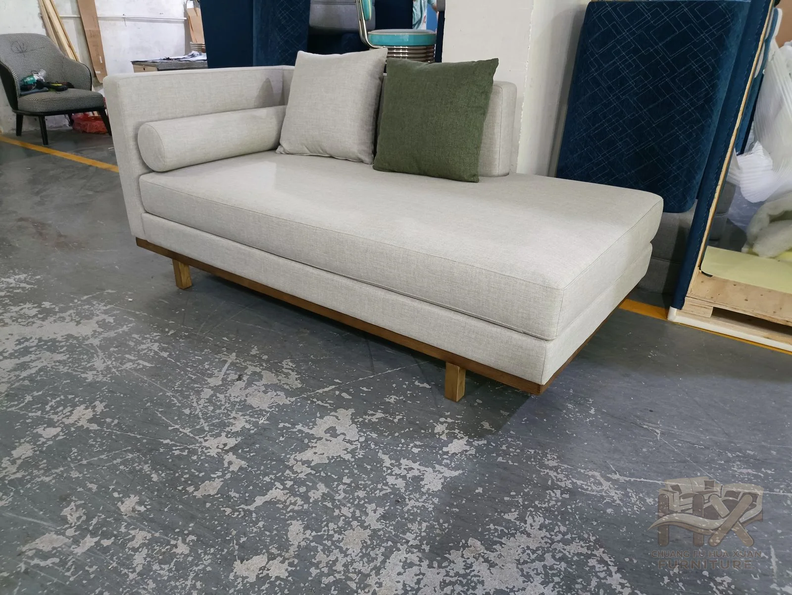 A white sofa has straight square arms, a low back and generously padded seat cushions.