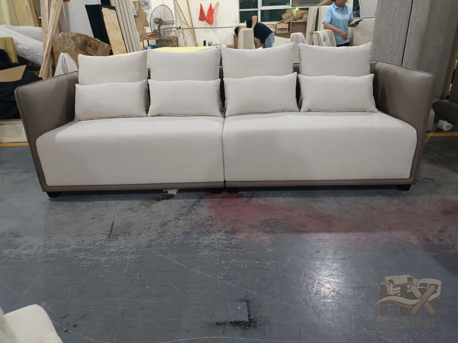 A white three-seat sofa uses a regular cushion row between straight low padded arms.