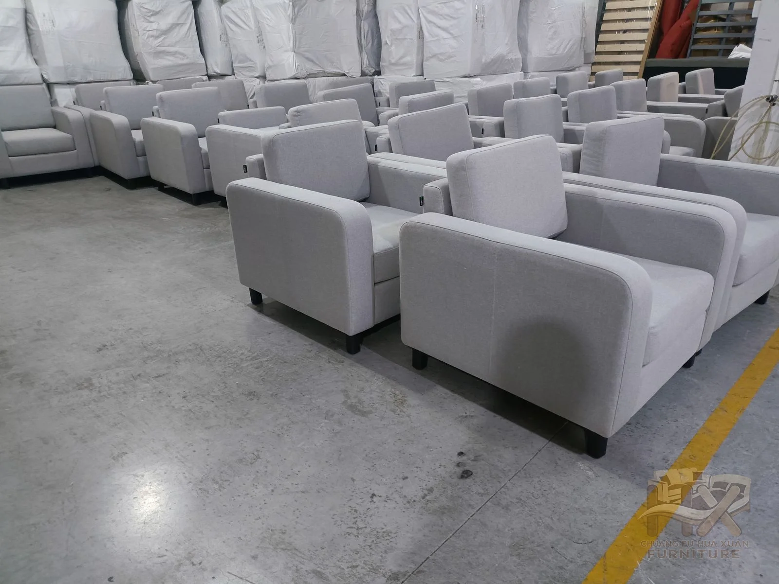 Grey padded modules form long sofa runs and corner arrangements with low straight backs.