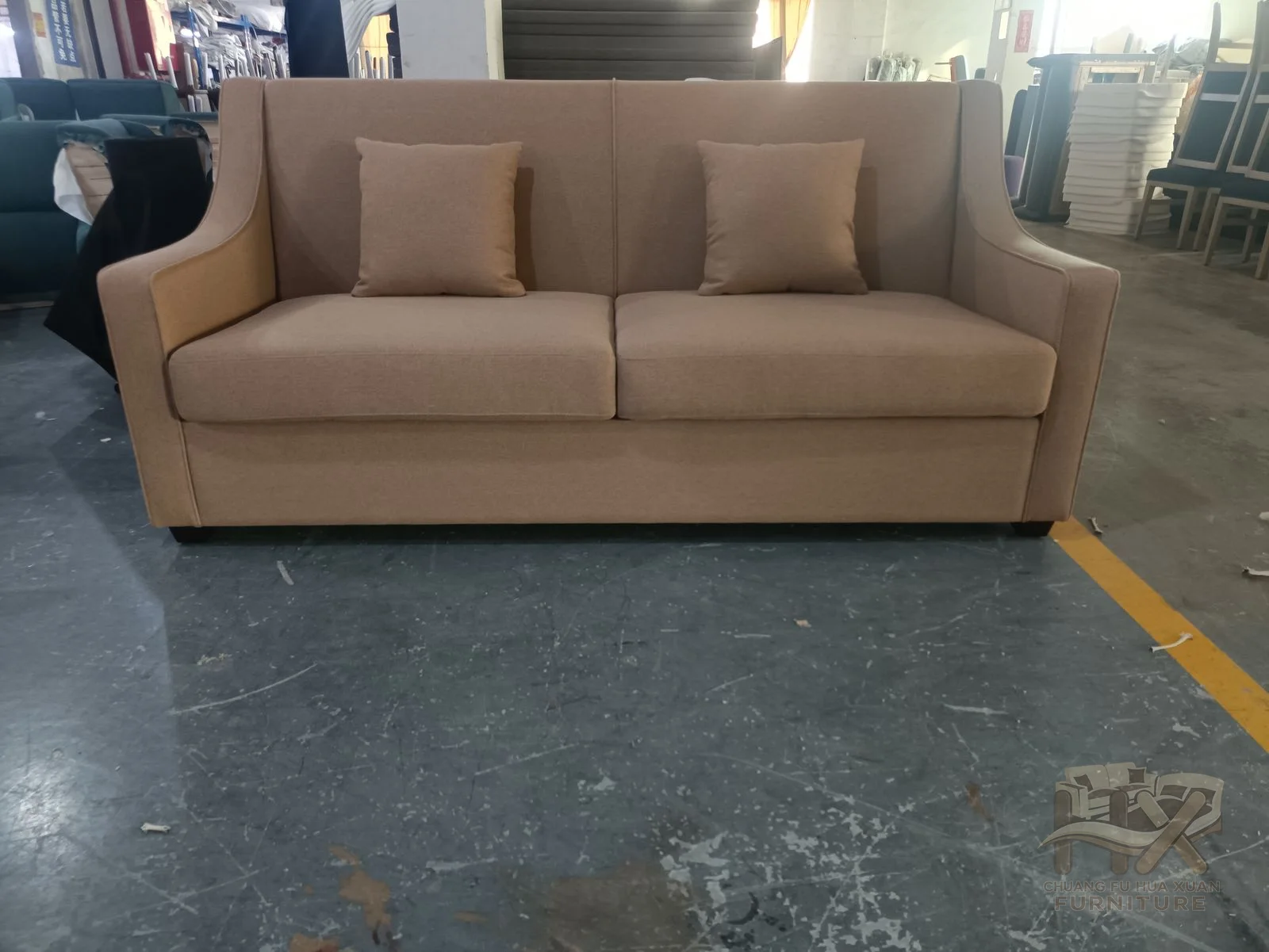 A sand-coloured sofa and companion chair share square padded arms and loose backs.