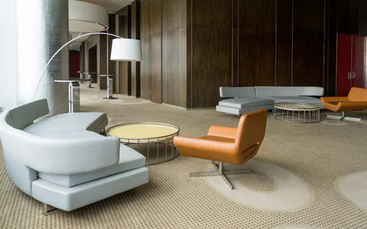 Concept office lounge with sofas, armchairs and low tables for reception seating