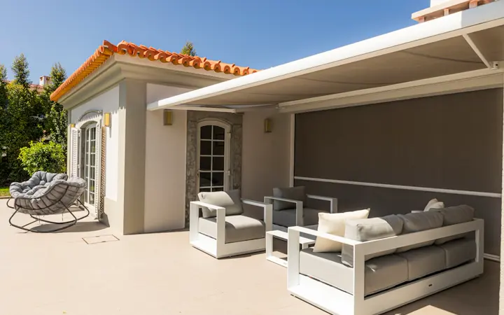 Concept outdoor patio with woven lounge chairs, sofa and coffee table