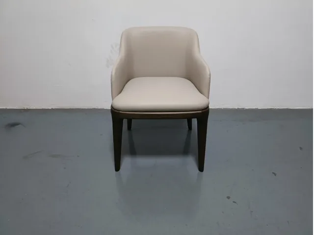 Cream upholstered dining chair shown front-on against a plain wall