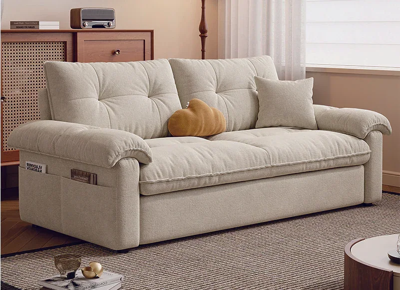 Ivory button-tufted manual pull-out sofa bed with soft rolled arms in sofa mode