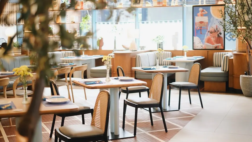 Restaurant dining zone with commercial tables, chairs and banquette seating
