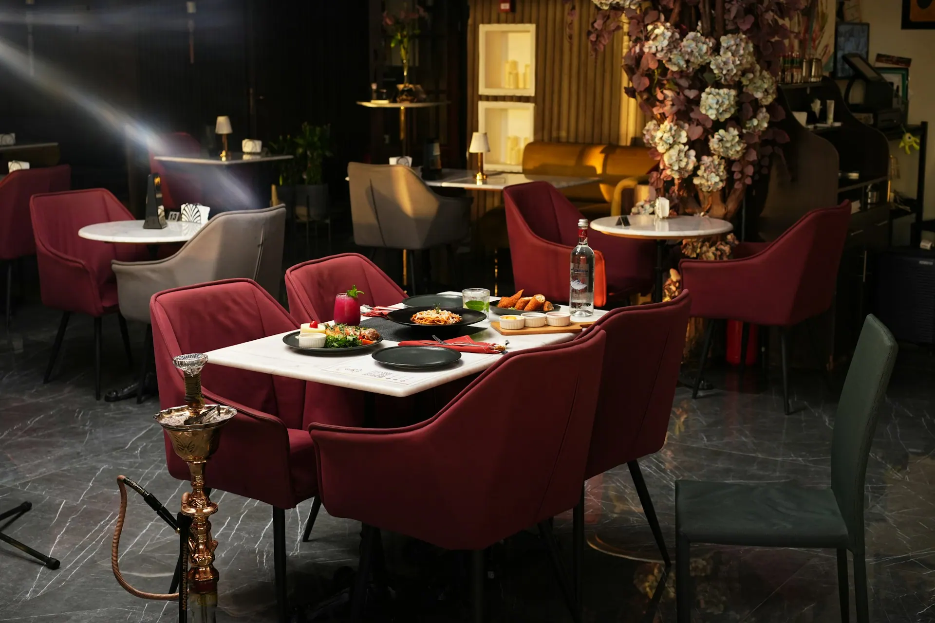 Commercial restaurant with dining chairs, tables, booth seating and bar area